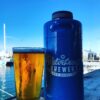 key west waterfront brewery growler mini keg in blue with beer in pint glass