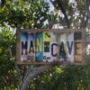 Man Cave license sign displayed on mangrove