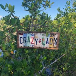 Crazy Lady license plate sign displayed hanging from mangroves