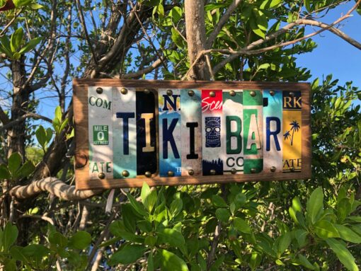 Tiki Bar sign displayed hanging from buttonwood tree